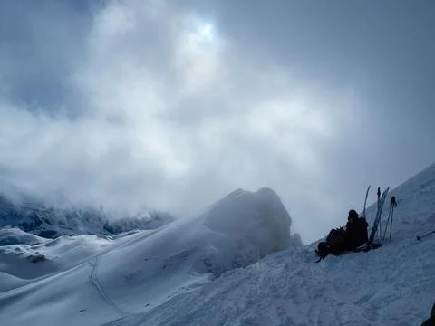 Ski tourers having a pause on the summit of Haengst, Switzerland Foto stock