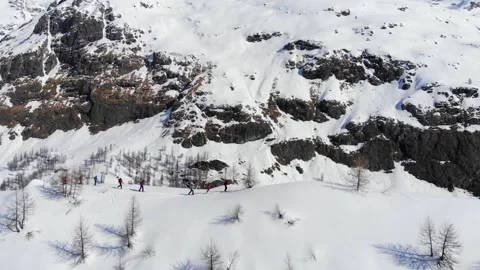 Ski touring group on skins uphill in a line. Ski touring in winter big mountains Stock Footage 150554765