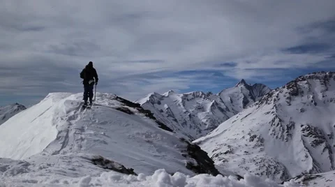 Ski touring on mountain peak Видео 49007209