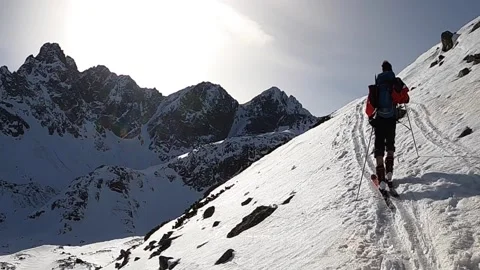 Ski Touring in mountains. Man walking in a winter landscape. Stock Footage 160122432