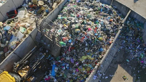 Skid loader scooping, lifting, and dumping garbage, top down aerial shot Stock Footage 234013729