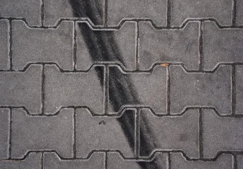 Skid marks on brick pavement closeup	 Stock Photos
