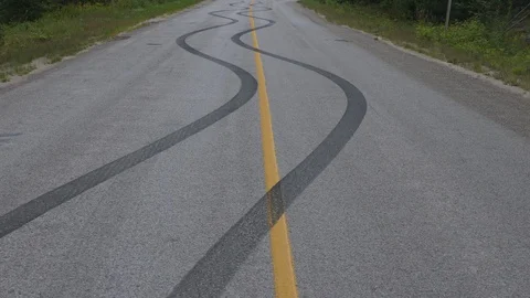 Skid marks on road from car doing a burn, Stock Video
