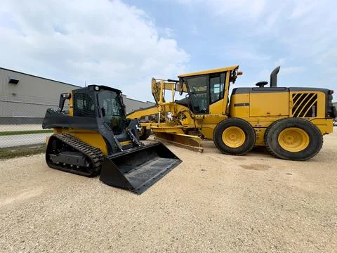 Skid-Steer  and a large loader on construction site Fotos de archivo