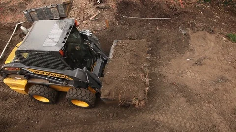 Skid Steer front loader carries a load of soil at residential construction site Stock-Footage 90591440