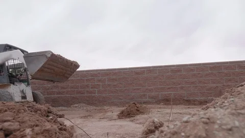 Skid Steer Pouring Dirt on Camera Stock Footage 127550883