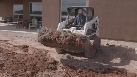 Skid Steer Tractor Doing some Dirt Work Stock Footage 128441623