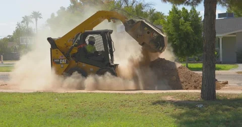 Skid Steer Unloading Dirt Stock Footage 138788638