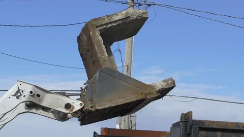 Skidloader Dumping Cement Block in Dump Truck Stock Footage 100833601