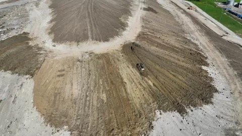 The skidster pushes the soil from the top of the mountain to the bottom. A Stock Footage 243342196