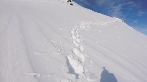 A skier with an action camera on his helmet climbing the snowy mountain Stock Footage 92436436