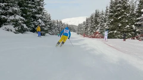 Skier athlete skiing down an alpine mount ski slope Video stock 271200464
