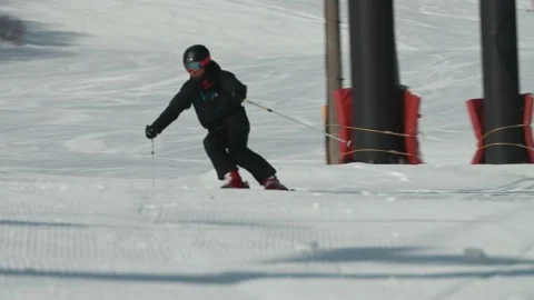 Skier in black riding down an empty ski resort Hakuba Japan Stock Footage 166369576