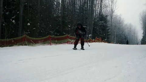 A skier descends from a mountain, a guy goes skiing in a ski complex Stock Footage 230878315