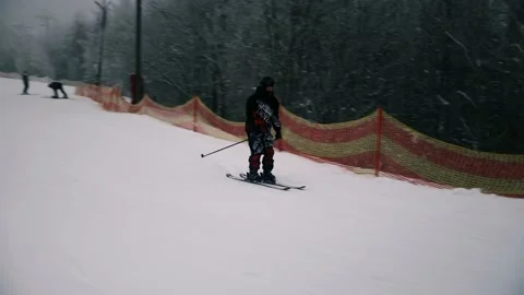 A skier descends from a mountain, a guy goes skiing in a ski complex Stock Footage 230881510