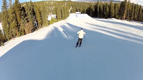 A skier does a backflip jump off a ramp at a ski resort. Stock Footage 71353943