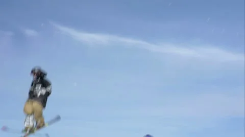 Skier does backside 540 off jump Stock Footage 61574577