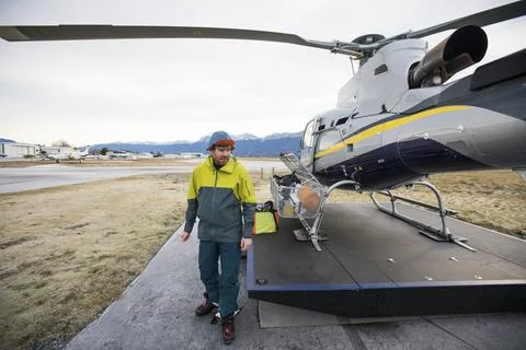 Skier does a final check of gear before helicopter take-off Fotos de archivo