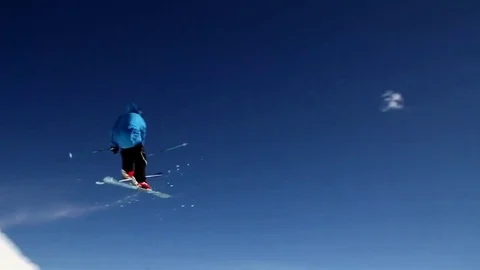 A skier doing a jumping trick on skis in the winter at a ski resort. Stock Footage 71354530