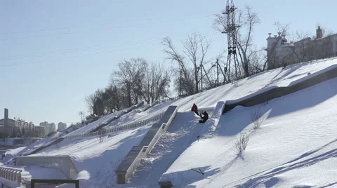 Skier doing a slide trick on a ledge in the street Stock Footage 64508493