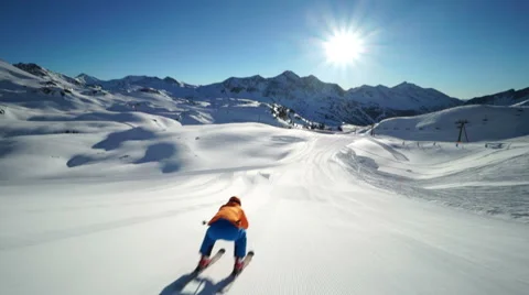 Skier in downhill position on empty ski piste Stock Footage