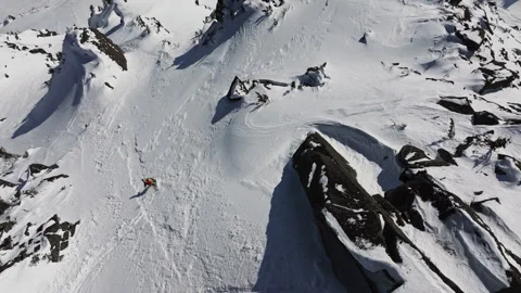 Skier enjoying fresh powder snow on a sunny day in the mountains Stock Footage 309965053