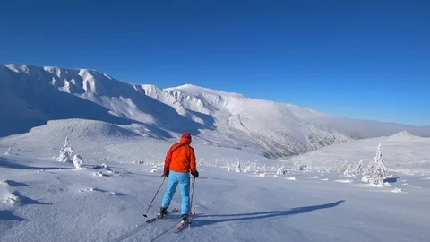 Skier falling down, follow shot. Freeride skiing . Bright sun, cold winter Stock Footage 120305630