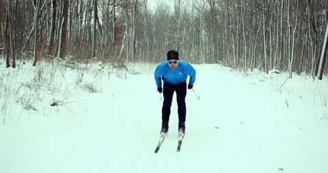 A skier in the forest. A man is doing cross-country skiing. Stock-Footage 294680162