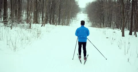 A skier in the forest. A man is doing cross-country skiing. Stock Footage 294680661