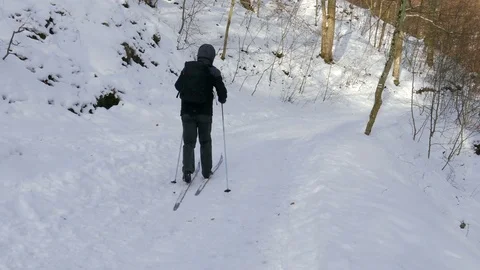 Skier. Forest scene. Man enjoy cross-country skiing in the woods Stock Footage