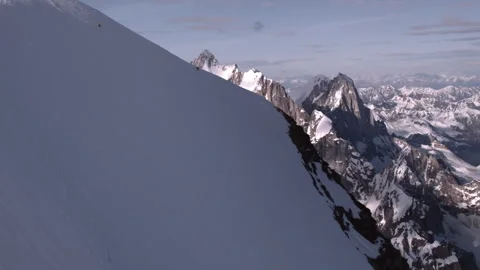 Skier freeriding down a steep snowy mountain slope Stock Footage 335105494