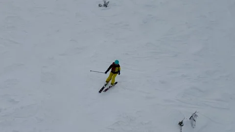 Skier going down by ski slope Stock Footage 245699164