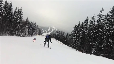 Skier going down the slope rear view Stock Footage 122850967