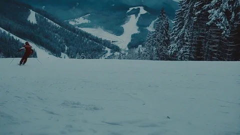 Skier going down the slope at a ski resort in the woods 動画素材 72143878