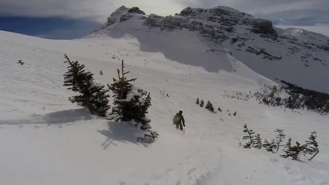 Skier jumping in between two trees Stock Footage 74536996