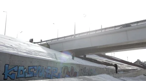 Skier jumping over the street gap on the bridge and sun background Stock Footage 64508328
