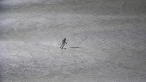 A skier kid sliding down a sparkling snowy hill in Levi ski resort in slo-mo Stock-Footage 123087963