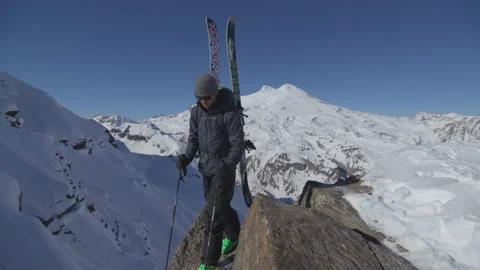 Skier on Mountain Top Walking Back Stock Footage 165624316