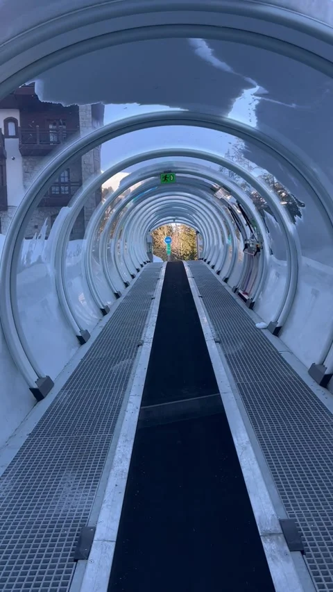 Skier moving up in a closed ski conveyor or magic carpet by winter Stock Footage 337200769