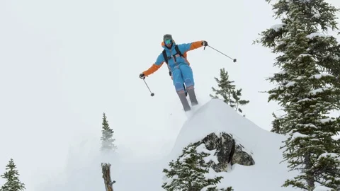 Skier performing a jump while skiing on the snowy mountain Видео 116631228