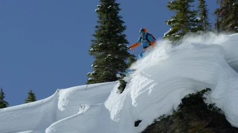 Skier performing a jump while skiing on the snowy mountain Stock Footage 116631329