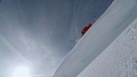 Skier performing trick while jumping from high snowy mountain during winter Stock Footage 116785501