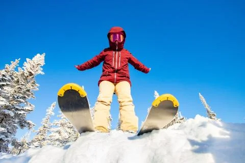 Skier is preparing for jump, lower angle of ski, blue sky winter forest 스톡 사진