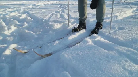 Skier preparing for movement by adjusting position on skis in snowy outdoor Stock Footage 327137429