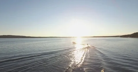 Skier Pulled by a Boat on a Lake at Sunset Stock Footage 79374220