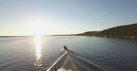Skier Pulled by a Boat on a Lake at Sunset - 2 Stock Footage 79374420