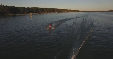 Skier Pulled by a Boat on a Lake at Sunset - 3 Stock Footage 79374904