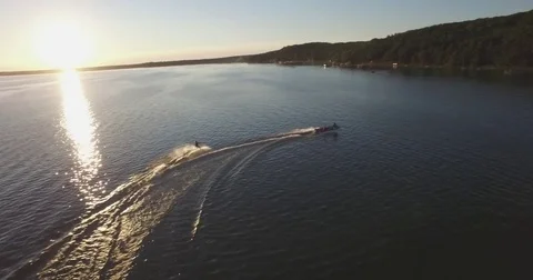 Skier Pulled by a Boat on a Lake at Sunset - 4 Stock Footage 79375836