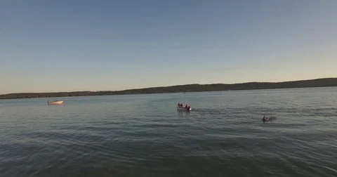 Skier Pulled by a Boat on a Lake at Sunset - 5 Stock Footage 79376106