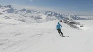 Skier Quickly Go Down On Ski Route In Sunny Weather Against Mountain Slopes Stock Footage